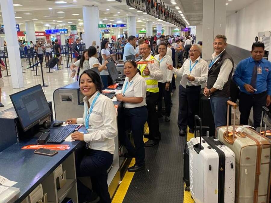 SATISERCOM traffic staff attending passengers at an airport check-in counter