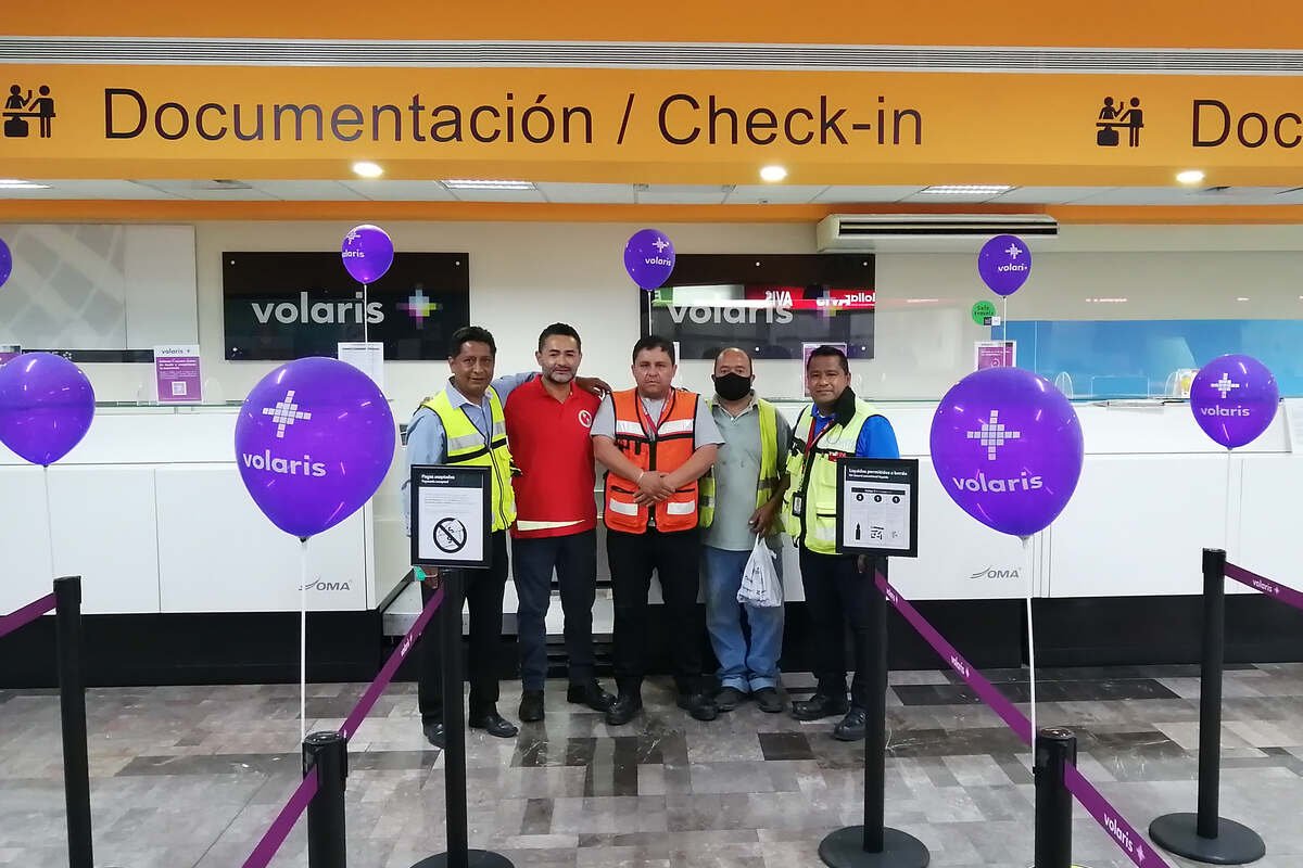 SATISERCOM staff at an airline check-in counter